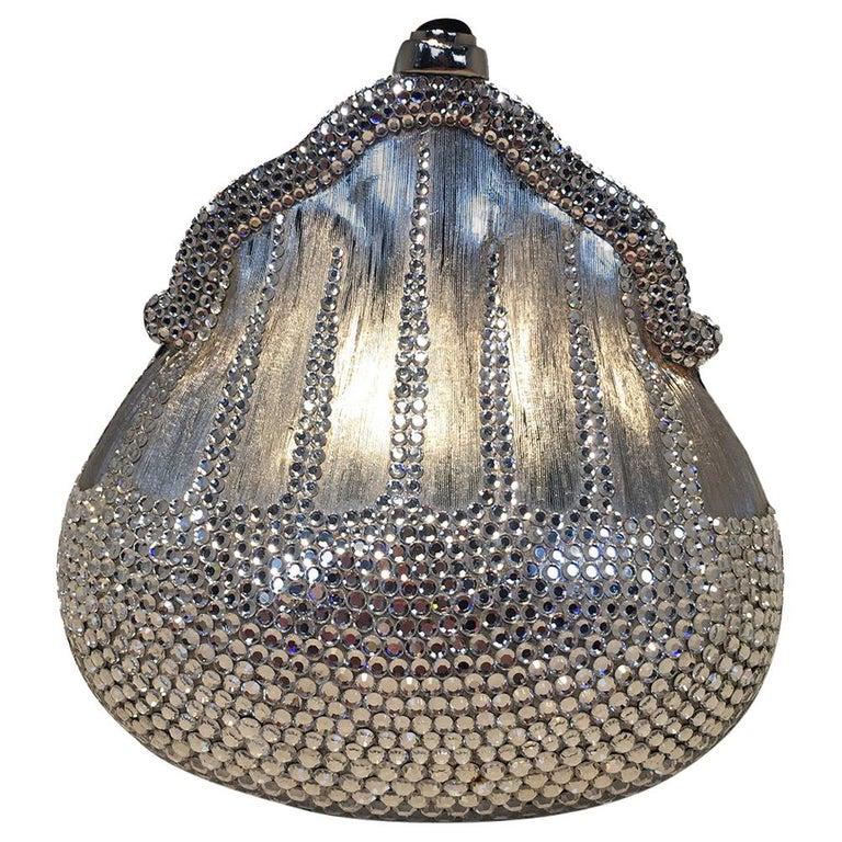Judith Leiber Silver Metal and Swarovski Crystal Coin: Judith Leiber Silver Metal and Swarovski Crystal Coin Pouch Minaudiere in excellent condition. Silver metal body in beautiful unique pouch shape trimmed with clear swarovski crystals covering the bott