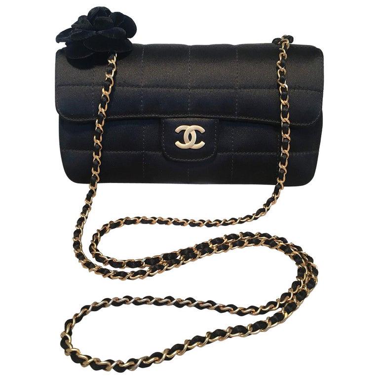 Chanel Quilted Black Silk Mini Camellia Classic Flap: Chanel Quilted Black Silk Mini Camellia Classic Flap Shoulder Bag in excellent condition. Square quilted black silk exterior trimmed with matte gold hardware and an adorable velvet camellia flower alo
