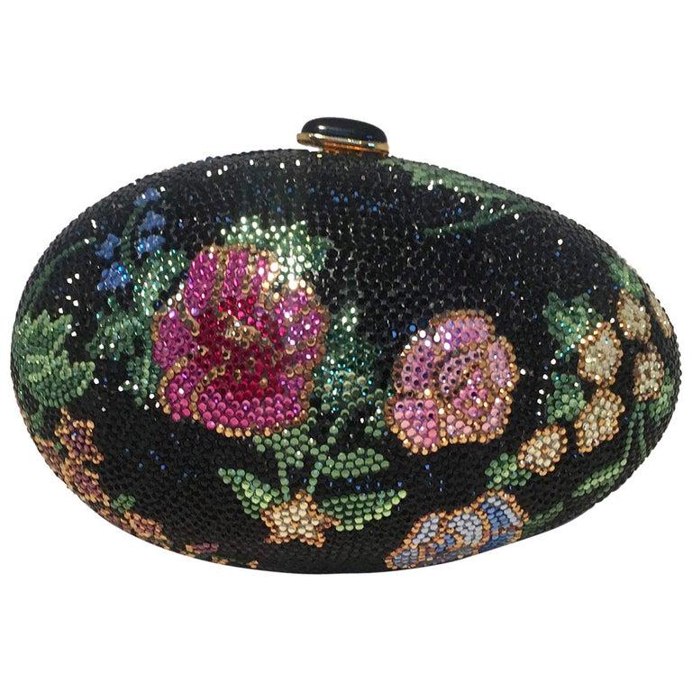 Judith Leiber Black Swarovski Crystal Floral Print: STUNNING JUDITH LEIBER swarovski crystal floral faberge egg minaudiere in excellent condition. Black swarovski crystal exterior with a multi-color floral design throughout the exterior. Top button clo