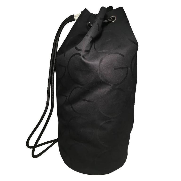RARE Gucci Black Canvas Sling Backpack Bag: RARE Gucci black canvas sling bag in excellent condition. Black woven canvas exterior with G for Gucci print woven throughout. 2 corded black shoulder strap on back. Can be worn as a shoulder bag, duf