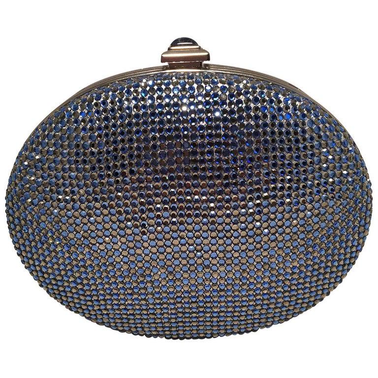 Judith Leiber Blue Crystal Minaudiere Evening Bag: Judith Leiber Blue Crystal Minaudiere Evening Bag Clutch in excellent condition. Blue and clear swarovski crystal exterior trimmed with silver hardware and a top push button closure. Silver leather li