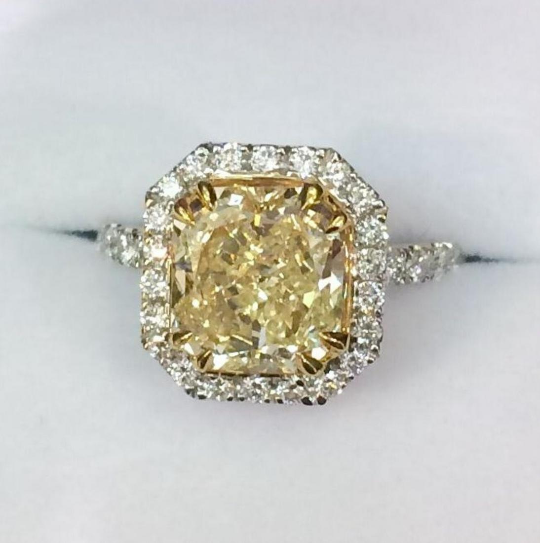 GIA 3.18ct Natural Fancy Yellow Diamond 18K White Gold: 18K White Gold / Natural Fancy Yellow Diamond : 3.18ct GIA # 1172238251 / Diamond 0.67ct *Fancy yellow diamond surrounded by diamonds and gilded detail adorning the ring's shank, the dazzling sparkle 