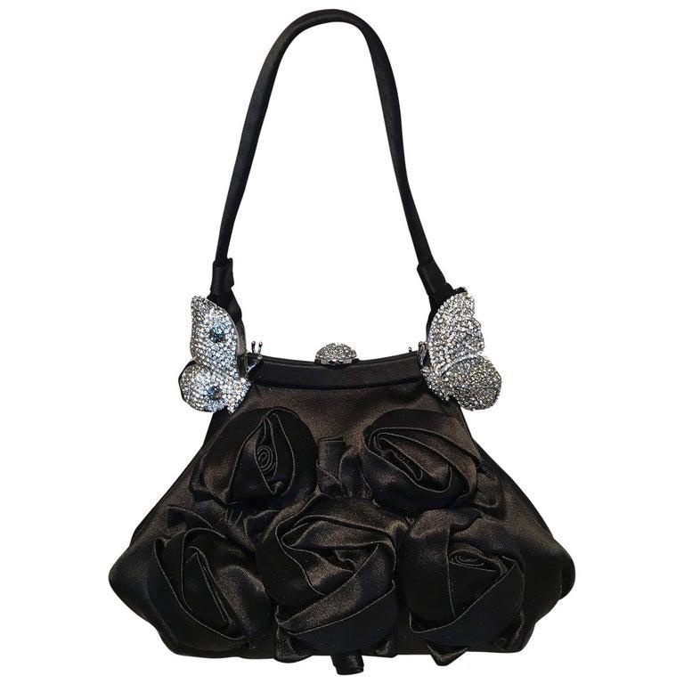 Valentino Black Silk Rose and Swarovski Crystal: Valentino Black Silk Rose and Swarovski Crystal Butterfly Evening Bag in excellent condition. Black silk exterior trimmed with silver hardware, black silk rosettes along the front side, and swarovski 