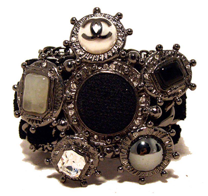 Chanel Black Wool and Gunmetal Charms Bracelet-limited: STUNNING RARE AUTHENTIC CHANEL black wool and gunmetal charms bracelet in MINT condition. Black wool woven through gunmetal hardware with a fabulous left embellishment. The focal point of this piece f