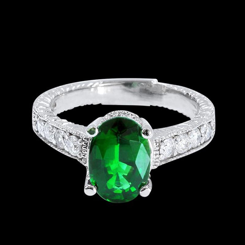 1.85CT NATURAL TSAVORITE 14K WHITE GOLD RING: 14K WHITE GOLD NATURAL TSAVORITE RING:4.46 GRAMS/DIAMOND:0.40CT/TSAVORITE:1.85CT/#GVR1018 **The rich mystical forrest green of the 1.85ct oval shape Tsavorite is at the center of this 14kt white gold