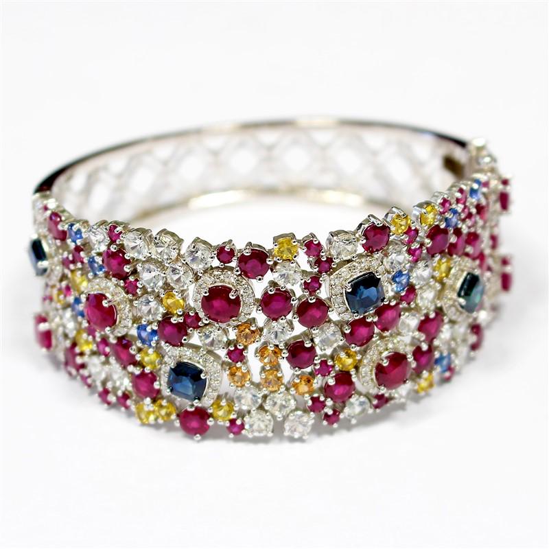 15.80ct Natural Burma Ruby and Multi Color NATURAL: 14K WHITE GOLD BANGLE 44.87GR / DIAMONDS 1.50CT / NATURAL BURMA RUBY'S 15.80CT / NATURAL ORANGE CEYLON SAPPHIRE 0.55CT / NATURAL YELLOW CEYLON SAPPHIRE 1.57CT / NATURAL WHITE CEYLON SAPPHIRE 5.74CT / 