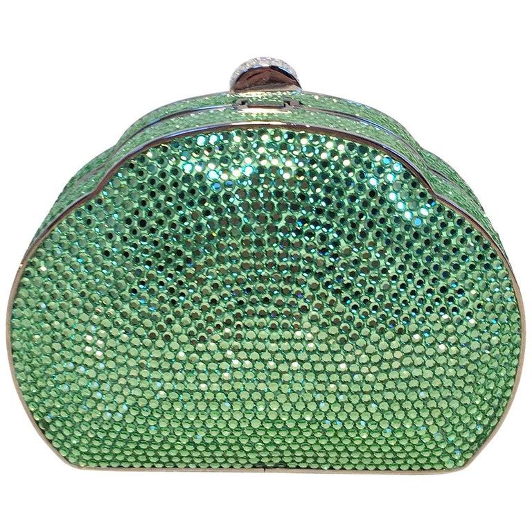 Judith Leiber Green Swarovski Crystal Minaudiere: Judith Leiber Green Swarovski Crystal Minaudiere Evening Bag in excellent condition. Green swarovksi crystal exterior trimmed with silver hardware. Top button closure opens to a silver leather interio