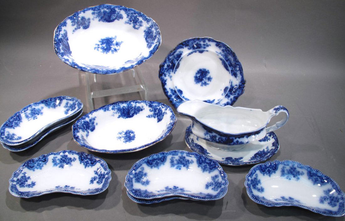 FLOW BLUE ROYAL STAFFORDSHIRE CHINA. 11 pieces.: FLOW BLUE ROYAL STAFFORDSHIRE CHINA. 11 pieces. "Arcadia" pattern. Including two vegetable dishes, one low dish, six bone dishes and a gravy boat and saucer.