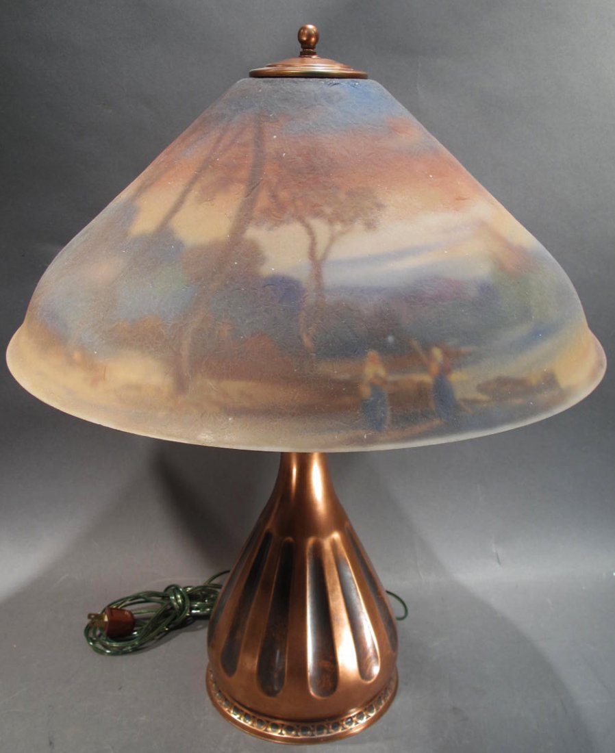 PAIRPOINT REVERSE PAINTED LAMP. Signed F. Guba on the: PAIRPOINT REVERSE PAINTED LAMP. Signed F. Guba on the landscape with castle ruins shade. The copper base is signed Pairpoint. Shade is 18" dia. Overall is 22"h. (Note: shallow 1/4"w rim chip. Base app