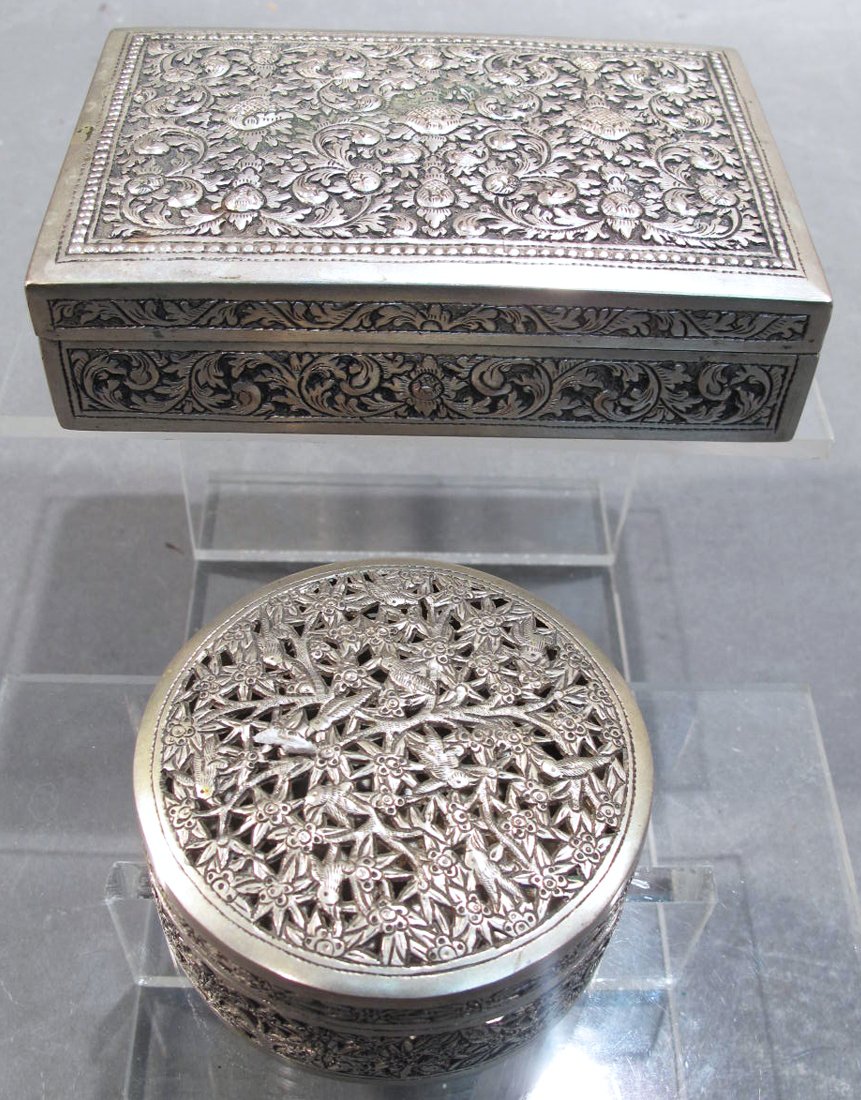 PAIR OF MIDDLE EASTERN SILVER DRESSER BOXES. One: PAIR OF MIDDLE EASTERN SILVER DRESSER BOXES. One rectangular and one round box with lid.