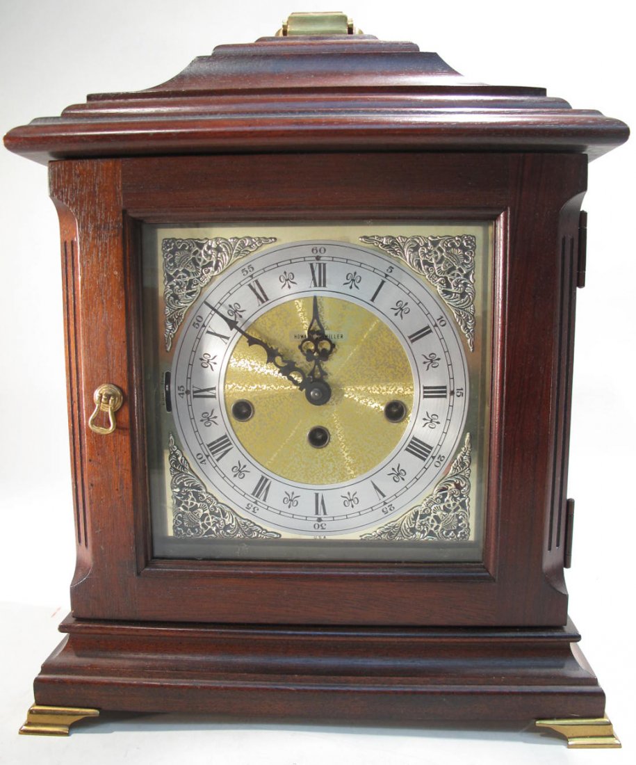 HOWARD MILLER LYNTON KEYWOUND MANTLE CLOCK. Carved: HOWARD MILLER LYNTON KEYWOUND MANTLE CLOCK. Carved cherry with chime silence option lever. 14 3/4"h., 12"w and 7"d.