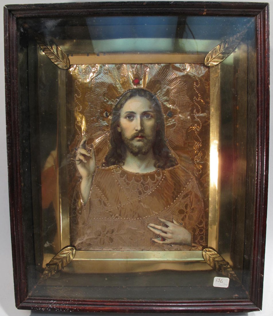 FRAMED ICON OF JESUS IN WOODEN SHADOW BOX. With copper: FRAMED ICON OF JESUS IN WOODEN SHADOW BOX. With copper and gold leaf cutout, four leaves on each corner and three jewels around the head. 14 1/2" x 12".