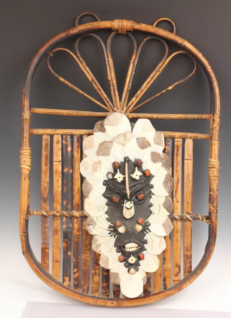 AFRICAN MASK WITH CROCODILE SCALES & PIRANHA TEETH: AFRICAN MASK WITH CROCODILE SCALES & PIRANHA TEETH Wooden African mask adorned with crocodile scales and piranha teeth. Also features small vertebrae and small rib bones. Attached to a woven reed wood