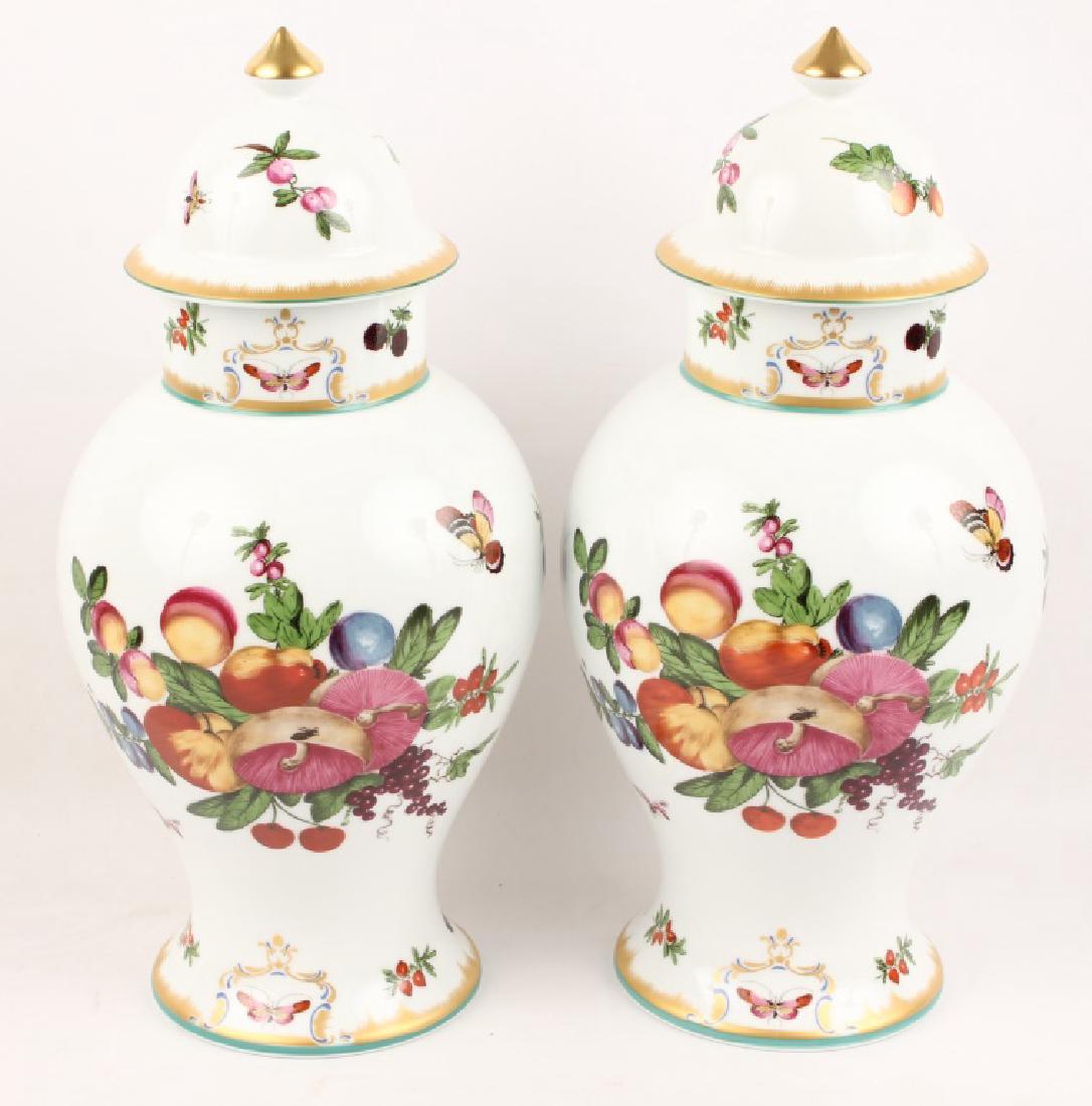 PAIR OF PORCELAIN URNS: PAIR OF PORCELAIN URNS Inspired by a platter made for the Duke of Gloucester in 1770, this modern Mottahedeh design blends brilliant hues of floral and fruit designs with gold accent. Size: 9x17" Ship