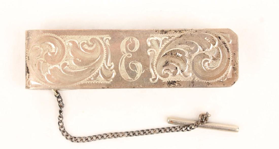 STARR'S RENO STERLING SILVER MONEY CLIP: STARR'S RENO STERLING SILVER MONEY CLIP Sterling Silver money clip with engraved pattern and "E" monogram to obverse, made by Starr's Silver Shop of Reno, Nevada. Weight: 30.2 grams Size: 2.75" Shippi