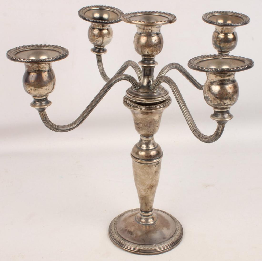 ROGERS STERLING WEIGHTED CANDELABRA: ROGERS STERLING WEIGHTED CANDELABRA Rogers sterling silver weighted candelabra. Marked to the underside of the base. Lot Location: #1 - Manor's Gallery Size: 10" Shipping / Pickup: We Can Ship This It