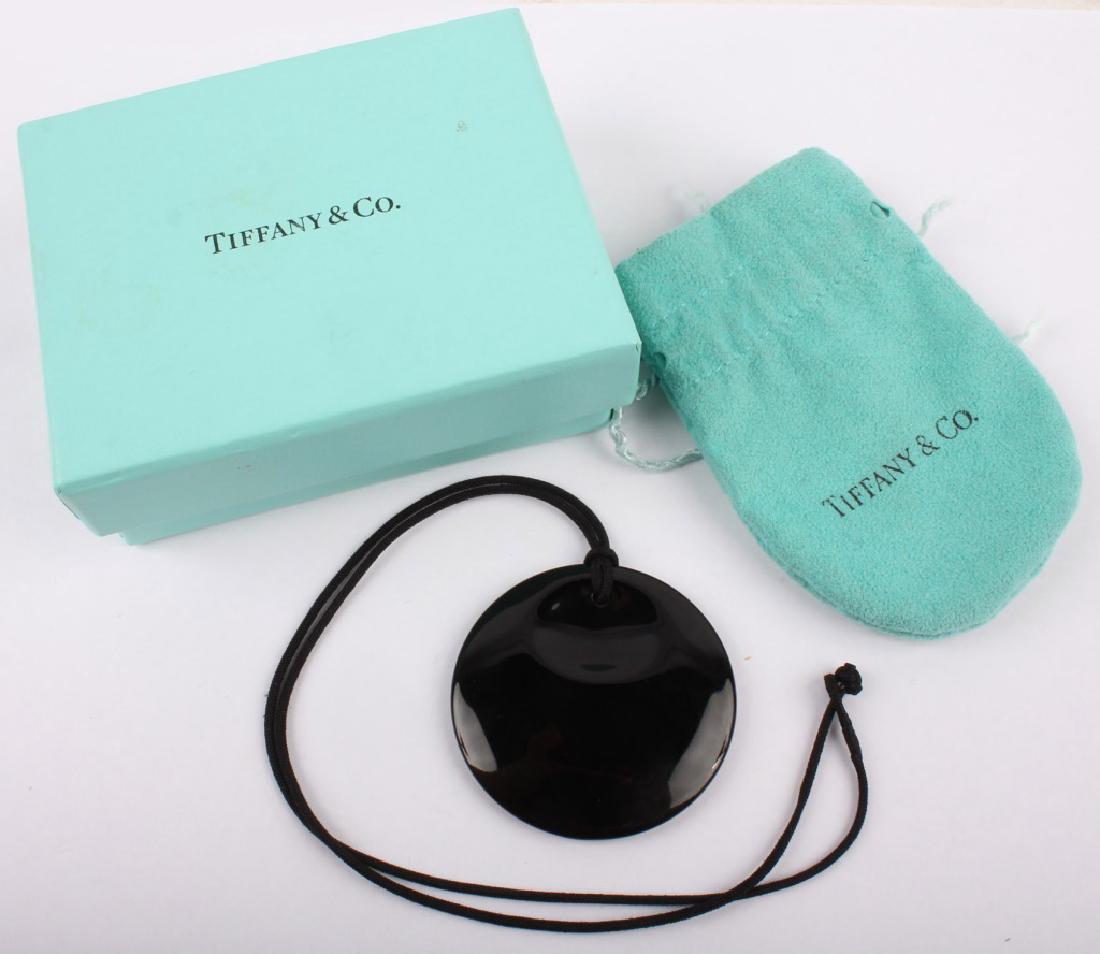 TIFFANY & CO. ELSA PERETTI BLACK LACQUER PENDANT: TIFFANY & CO. ELSA PERETTI BLACK LACQUER PENDANT Ladies Tiffany & Co. black lacquer "Elsa Peretti" Japan pendant on black cord necklace. Accompanied by pouch and box. Weight: 5.4 grams Size: 2" Pendan