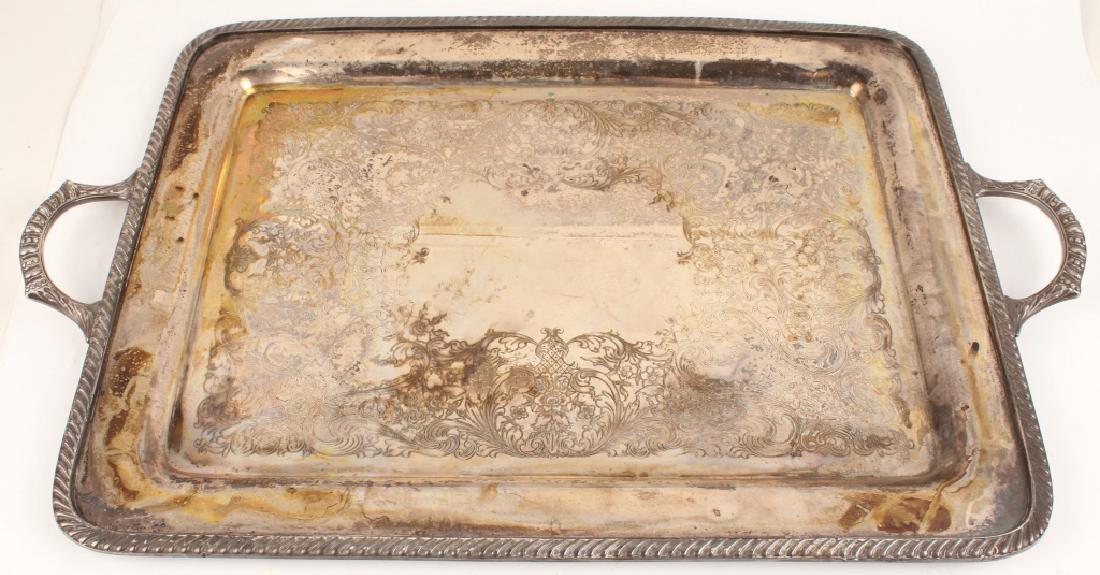 SILVER PLATE WAITERS TRAY BY WM ROGERS: SILVER PLATE WAITERS TRAY BY WM ROGERS Silver plate waiter tray with handles by WM Rogers. Silver on copper material. Weight: Entire tray 4619.5 Size: 27.5 x 17.5" Shipping / Pickup: Buyer Pick Up, 3r