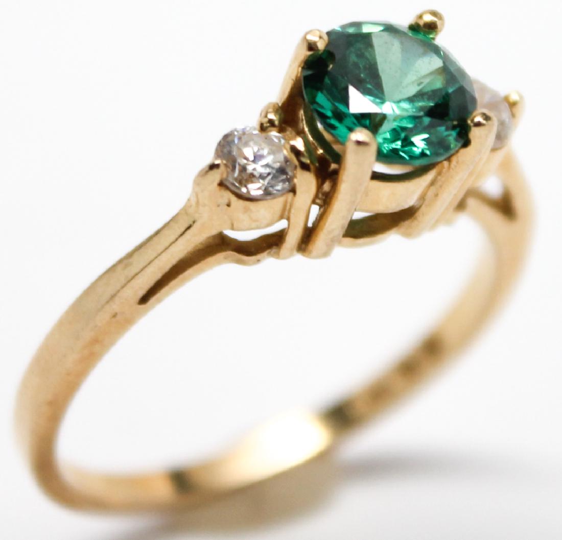 LADIES 14K YELLOW GOLD CZ FASHION RING: LADIES 14K YELLOW GOLD CZ FASHION RING Ladies 14k yellow gold cubic zirconia accented fashion ring with a green colored stone. Weight: 2.8 Grams Size: 8.25 Shipping / Pickup: We Can Ship This Item