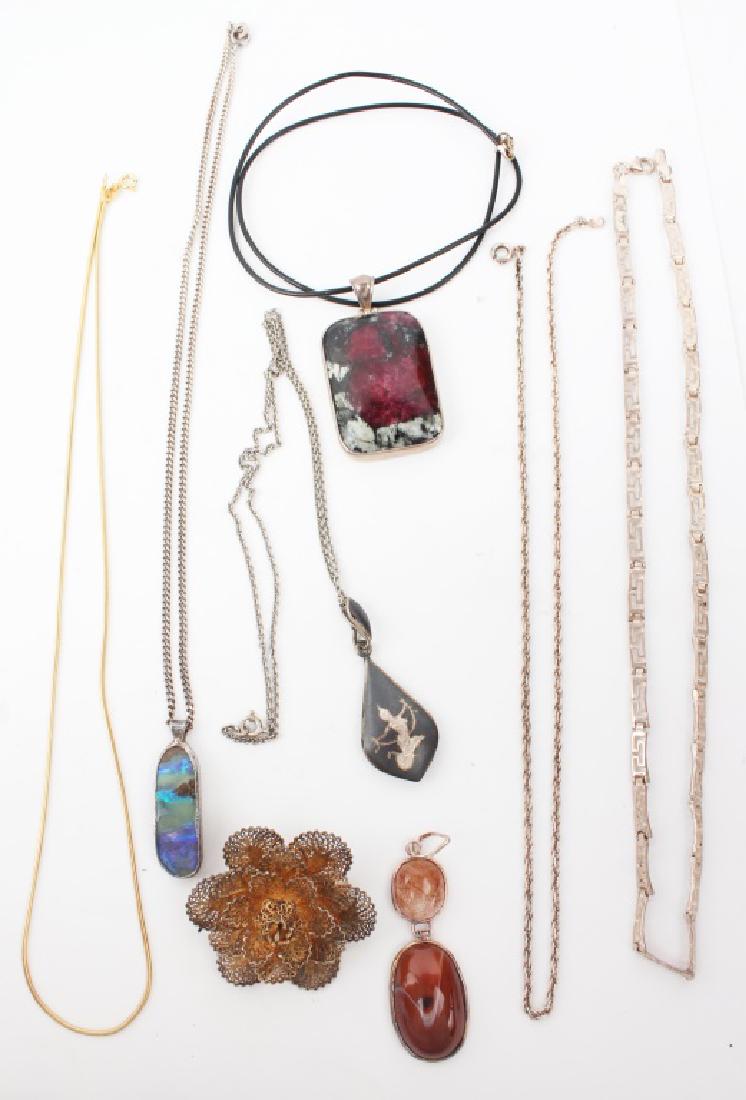 STERLING SILVER NECKLACES & PENDANTS: STERLING SILVER NECKLACES & PENDANTS Sterling silver necklaces and pendants, includes: carnelian, jasper, and opal. Also includes a vermeil flower brooch. Weight: 79.2g Shipping / Pickup: We Can Ship 