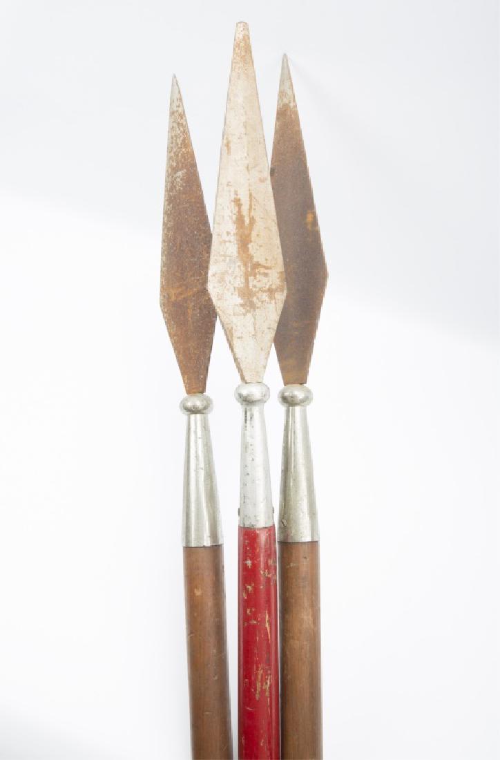LONG WOODEN SPEARS -- LOT OF THREE: LONG WOODEN SPEARS -- LOT OF THREE Lot of three wooden spears, each with metal tips. One painted red. Size: 72" to 82" Shipping / Pickup: Buyer Pick Up, 3rd Party