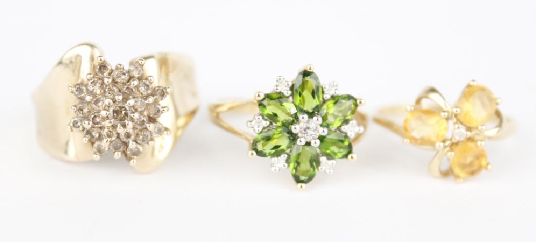 10K YELLOW GOLD GEMSTONE RINGS - LOT OF THREE: 10K YELLOW GOLD GEMSTONE RINGS - LOT OF THREE 10k yellow gold gemstone fashion rings - Lot of three. Stones include Diamonds, Citrine, and Peridot. Weight: 10.0 g Size: 6