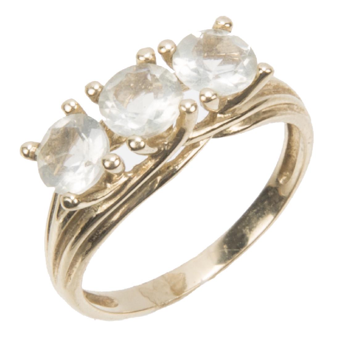 10K YELLOW GOLD AND WHITE TOPAZ RING: 10K YELLOW GOLD AND WHITE TOPAZ RING 10K yellow gold and white topaz ring. (3) 5mm round cut white topaz. Weight: 2.5 g Size: 6