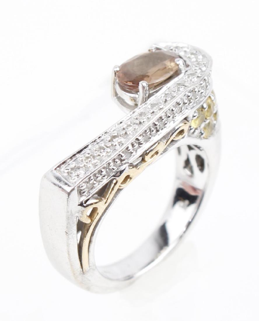 LADIES 14K WHITE GOLD SMOKEY QUARTZ RING: LADIES 14K WHITE GOLD SMOKEY QUARTZ RING Ladies 14k white gold fashion ring with smokey quartz oval center stone. Modern style design with diamond accents. Weight: 7.1 g