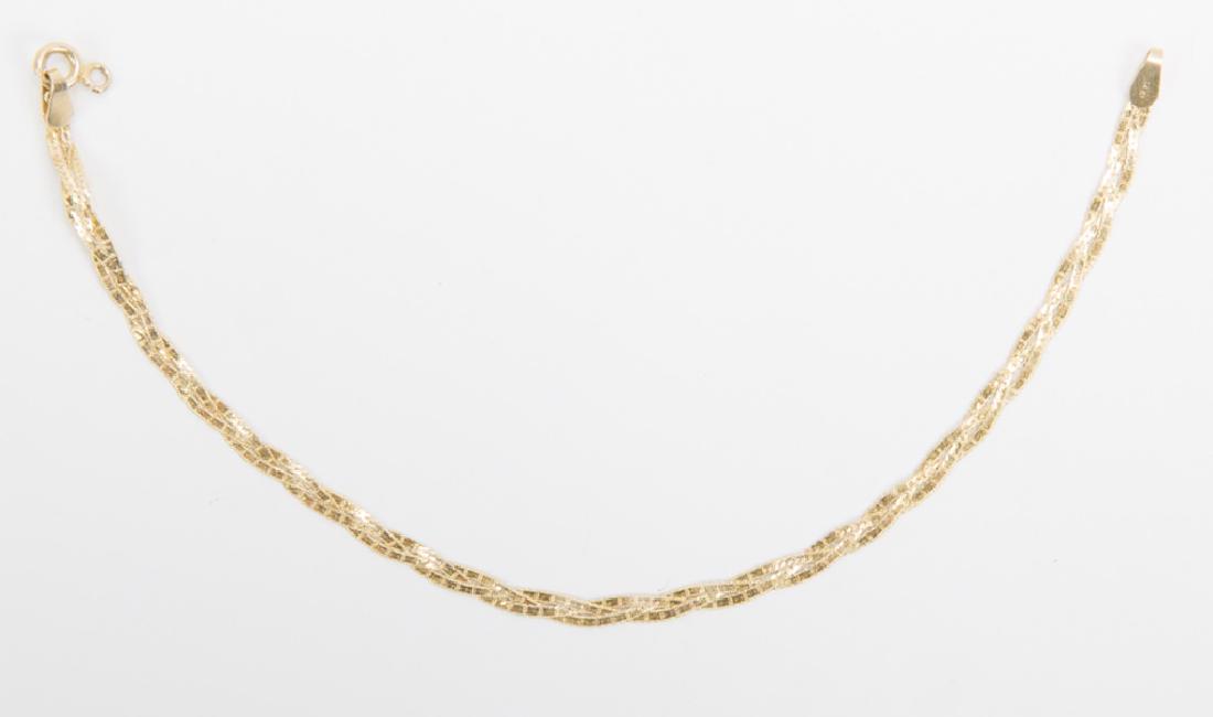 LADIES 14K YELLOW GOLD FLAT WOVEN BRACELET: LADIES 14K YELLOW GOLD FLAT WOVEN BRACELET Ladies 14k yellow gold flat twisted chain three strand bracelet. Weight: 1.8 grams Size: 7"