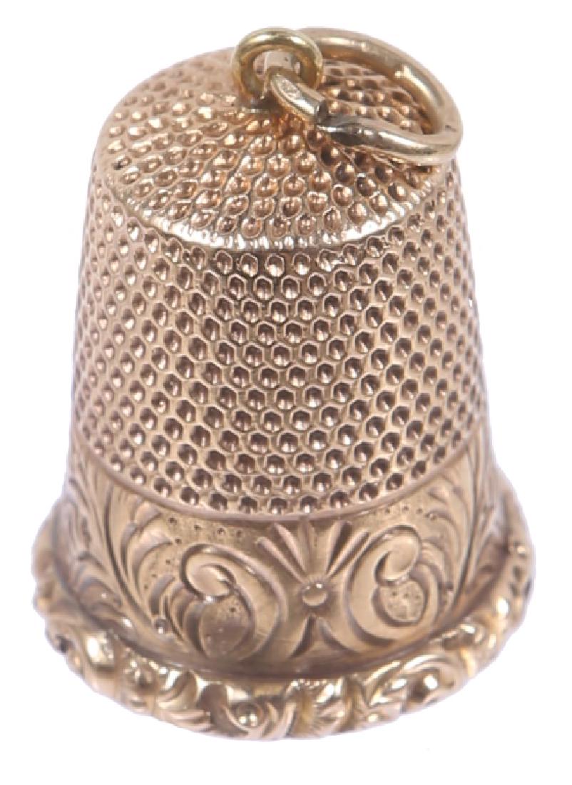 14K YELLOW GOLD ETCHED THIMBLE: 14K YELLOW GOLD ETCHED THIMBLE Antique 14k yellow gold sewing thimble, etched floral pattern inscribed "Dollie". Weight: 4.5 grams Size: 1"