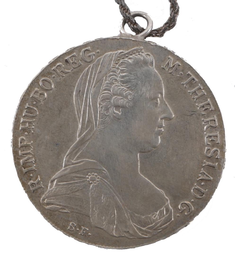 STERLING SILVER AUSTRIA THALER NECKLACE PENDANT: STERLING SILVER AUSTRIA THALER NECKLACE PENDANT Sterling silver twisted rope chain necklace with Austria Mother Theresa thaler 1780 coin. Weight: 35.4 grams Size: 24"