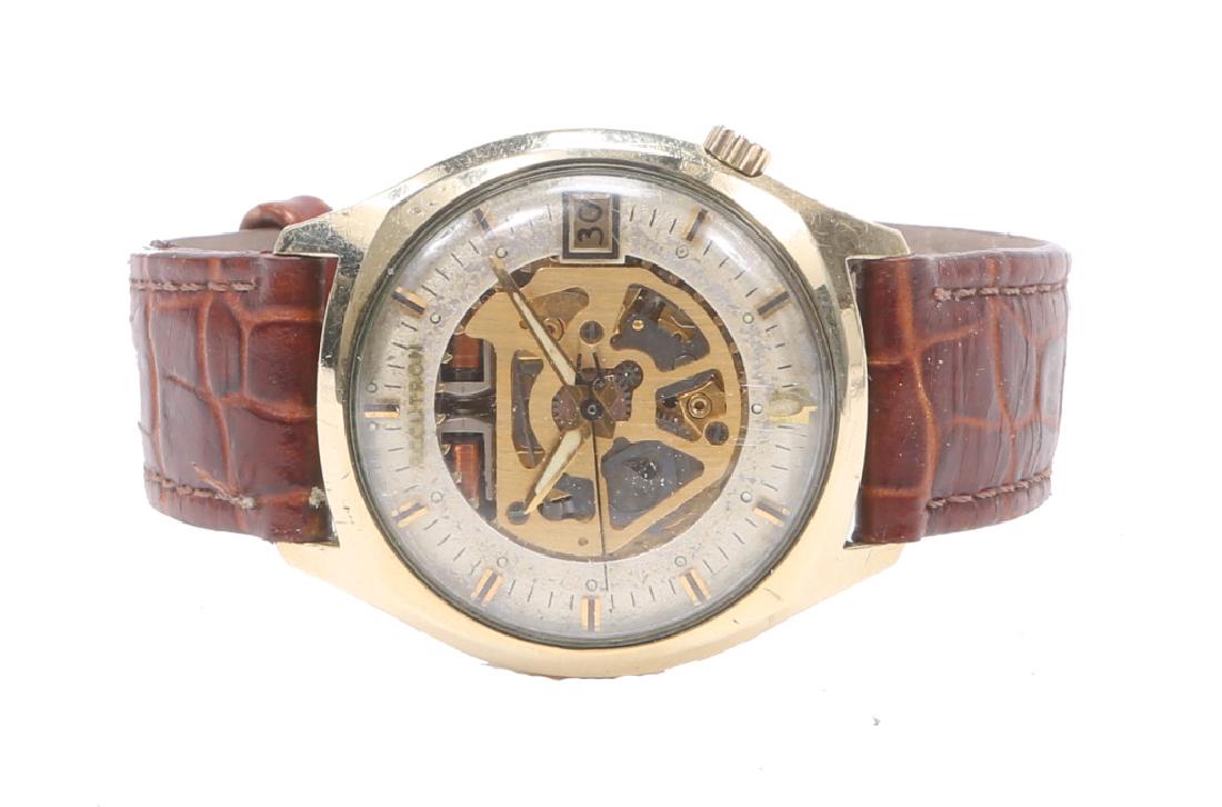 MEN`S BULOVA ACCUTRON GOLD FILLED SKELETON WATCH: MEN`S BULOVA ACCUTRON GOLD FILLED SKELETON WATCH Men's 14kt gold filled Bulova Accutron calendar wristwatch to date c. 1970, skeleton dial with applied gold batons. Weight: 39.3 grams Size: 34mm
