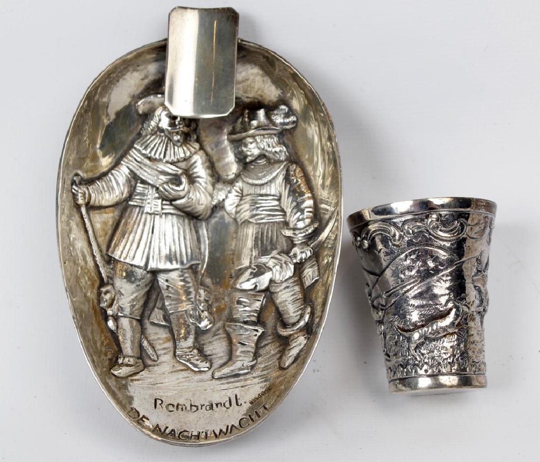 GERMAN STERLING SILVER ASHTRAY & SHOT GLASS: GERMAN STERLING SILVER ASHTRAY & SHOT GLASS German silver ashtray with Rembrandt carving, and sterling silver wildlife scene shot glass. Weight: 141.0 g
