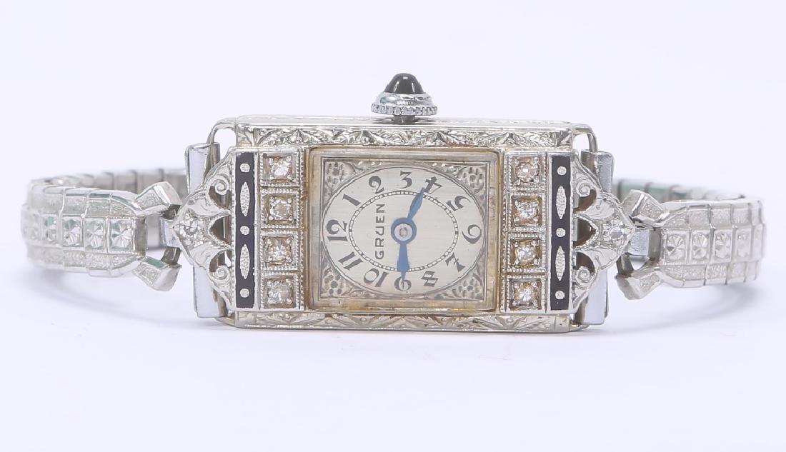 LADIES GRUEN 14K DIAMOND ENAMEL WRISTWATCH: LADIES GRUEN 14K DIAMOND ENAMEL WRISTWATCH Ladies Gruen manual wind wristwatch in 14k white gold case, black enamel accents with ten 2mm European cut diamonds. CAS monogram. Weight: 22.0 grams Size: 1