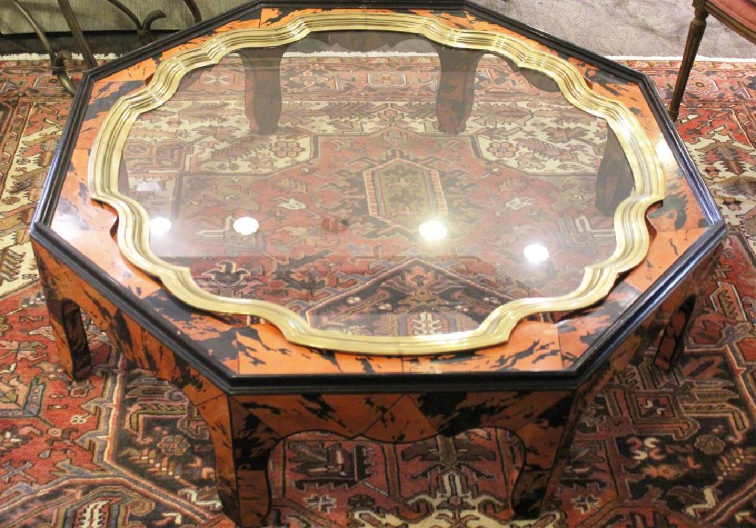 MID CENTURY MODERN OCTAGONAL COFFEE TABLE: MID CENTURY MODERN OCTAGONAL COFFEE TABLE Mid Century modern orange and black laminate coffee table base with gold framed glass inlay center. Size: 48" diameter x 15" tall