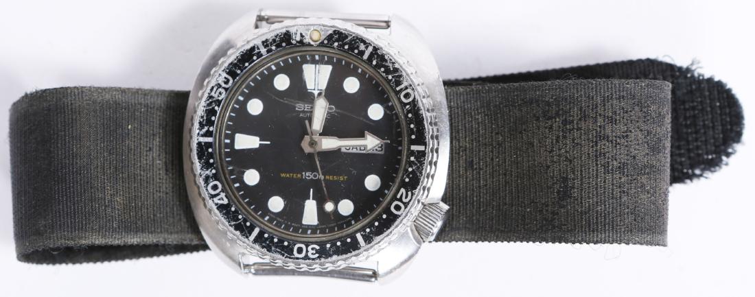 SEIKO AUTOMATIC DIVER STEEL WRISTWATCH 6309-7049: SEIKO AUTOMATIC DIVER STEEL WRISTWATCH 6309-7049 Seiko Automatic Water Resistant 150M steel case black bezel day date "Turtle", reference 6309-7049. Generic strap. Weight: 88.9 grams Size: 45mm