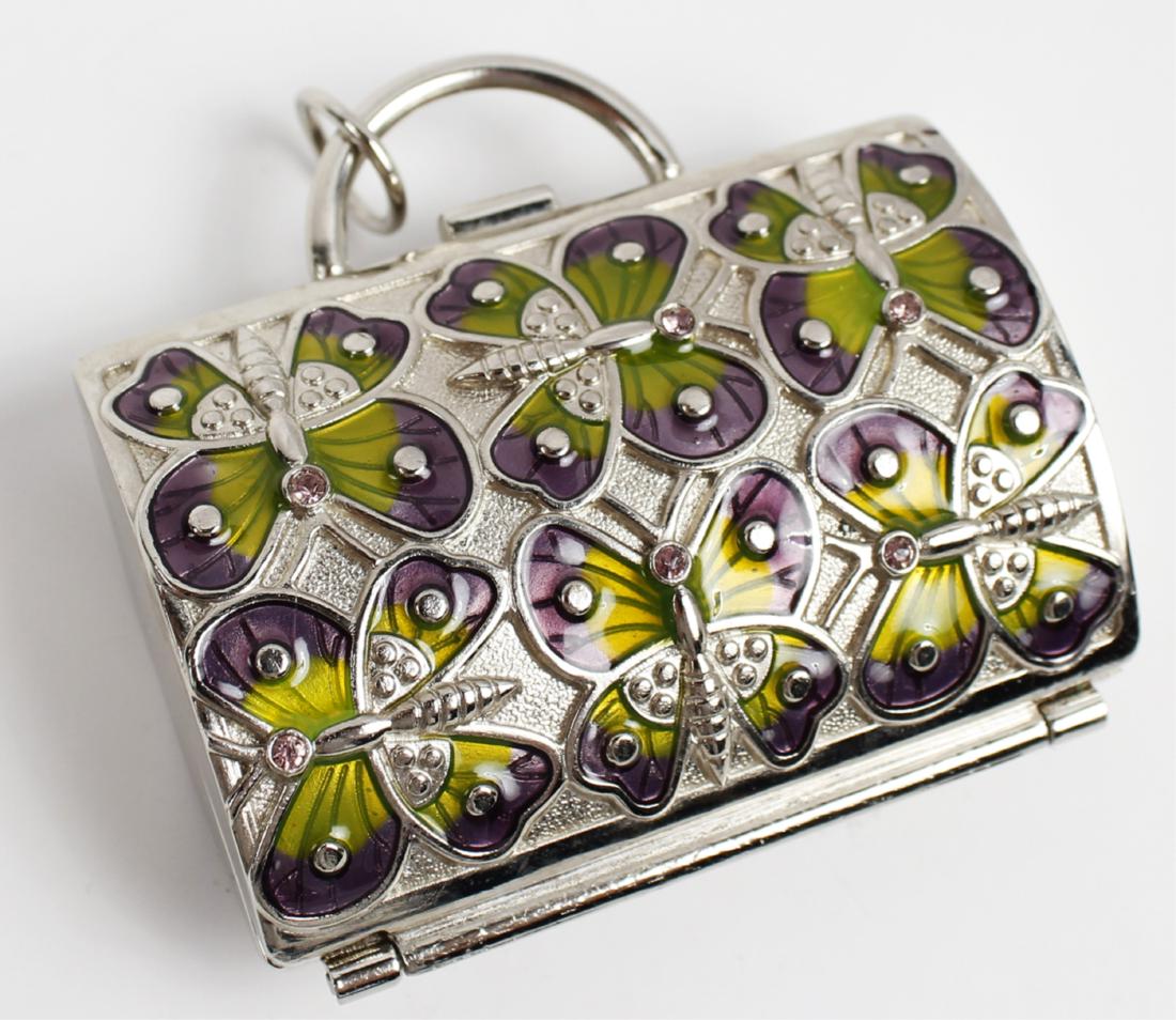 ENAMEL BUTTERFLY JUDITH LEIBER KEYCHAIN BOX: ENAMEL BUTTERFLY JUDITH LEIBER KEYCHAIN BOX Enamel butterfly key chain or pill box, marked "Judith Leiber for Neiman Marcus". 2.5" x 1.75"