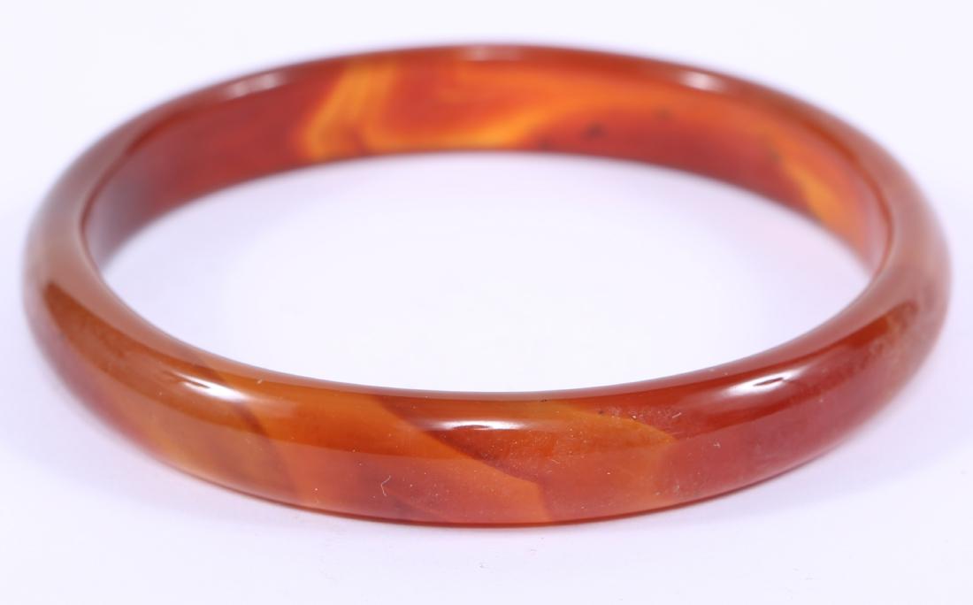 CHINESE CARVED CARNELIAN BANGLE BRACELET: CHINESE CARVED CARNELIAN BANGLE BRACELET Chinese red carnelian bangle bracelet. Weight: 19.1 grams Size: 2.75"