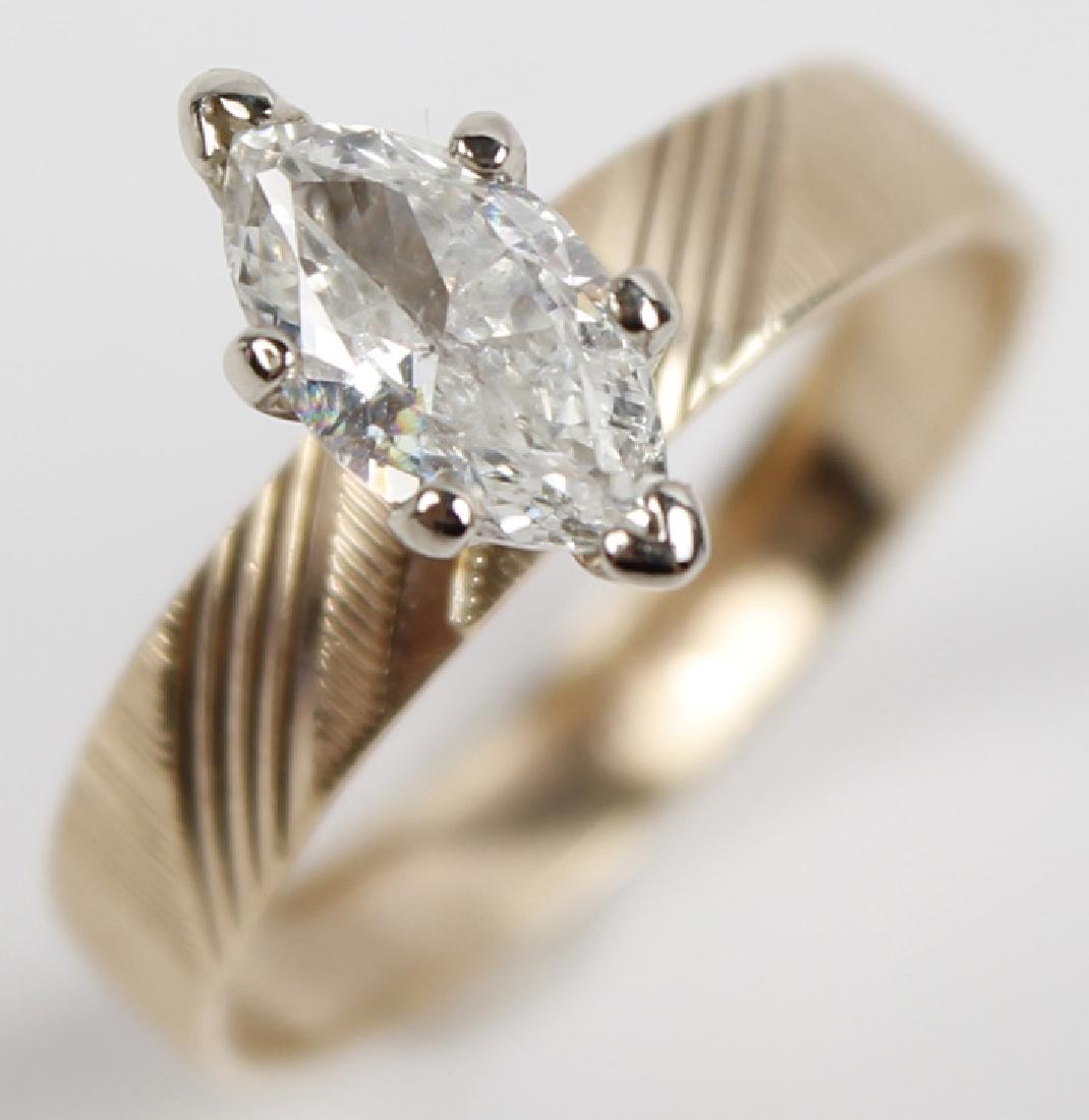 10K YELLOW GOLD DIAMOND SOLITAIRE ENGAGEMENT RING: 10K YELLOW GOLD DIAMOND SOLITAIRE ENGAGEMENT RING 10K yellow gold diamond solitaire engagement ring. Marquis cut 0.70ct SI1 to SI2 clarity, white color. 4mm wide band Weight: 2.2 g Size: 7