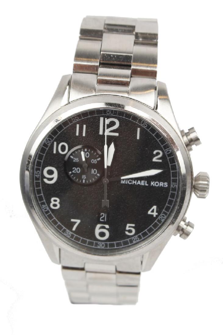 MENS MICHAEL KORS STAINLESS STEEL WATCH: MENS MICHAEL KORS STAINLESS STEEL WATCH Stainless steel case with a stainless steel bracelet. Fixed stainless steel bezel. Black dial with luminous hands and Arabic numeral hour markers. Minute marker