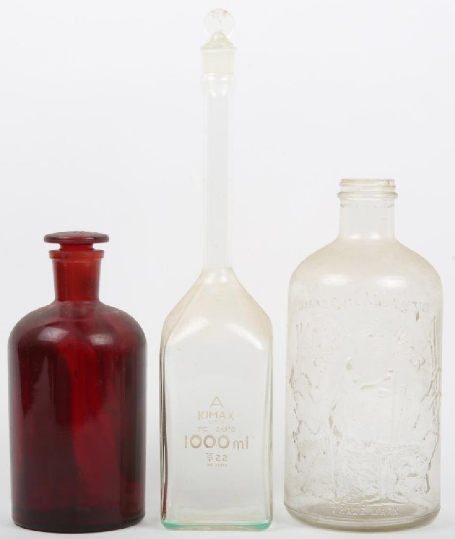 CHEMUNG SPRING GLASS WATER BOTTLE, PYREX, & MORE: CHEMUNG SPRING GLASS WATER BOTTLE, PYREX, & MORE Chemung Spring glass water bottle, Kimax USA 1000ml bottle, and red glass Pyrex laboratory bottle (Pyrex 29). Size: Tallest : 15.5"