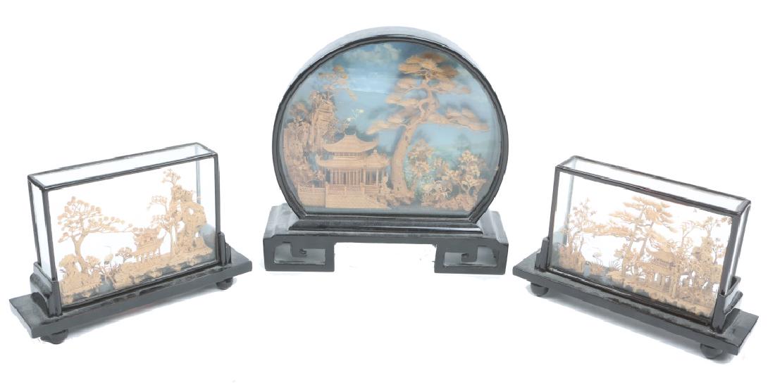 CHINESE CARVED CORK WOOD LANDSCAPE - LOT OF 3: CHINESE CARVED CORK WOOD LANDSCAPE - LOT OF 3 Lot of three Chinese cork carved wood landscape miniatures, each depicting tall trees over pagodas. Set in wood and glass panel cases. Size: 8 to 9"