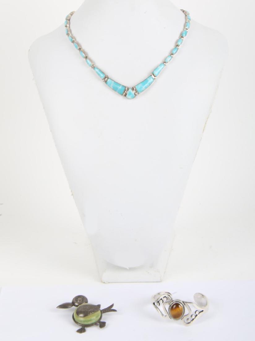 LADIES STERLING SILVER TAXCO JEWELRY - LOT OF 3: LADIES STERLING SILVER TAXCO JEWELRY - LOT OF 3 Lot of three sterling silver Taxco Mexico jewelry items, one tigers eye cuff bracelet, one agate bird brooch, and one Larimar link necklace. Weight: 81.