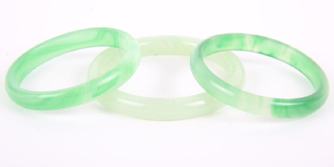 GREEN JADE BANGLE BRACELETS - LOT OF 3: GREEN JADE BANGLE BRACELETS - LOT OF 3 Lot of three green jade bangle bracelets, two matched at 75mm round and one 87mm. Weight: 117.7 grams