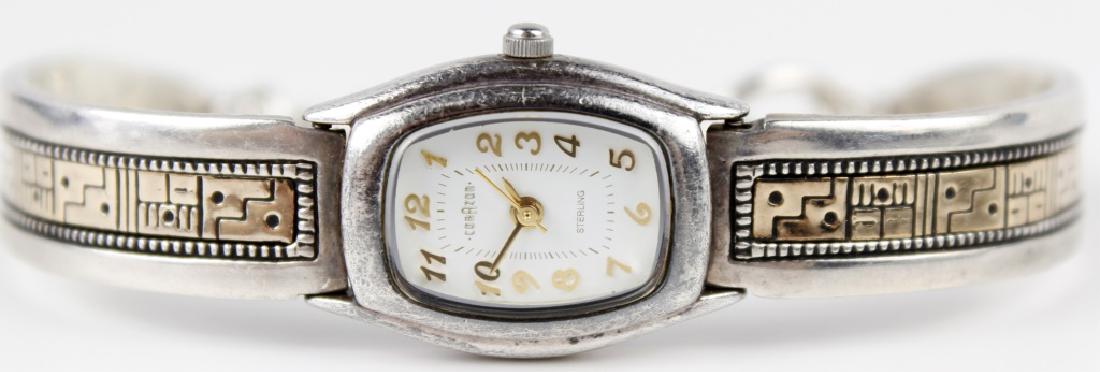 STERLING SILVER AND 14K YELLOW GOLD LADIES WATCH: STERLING SILVER AND 14K YELLOW GOLD LADIES WATCH Sterling silver and 14k yellow gold detailed ladies wristwatch. Chain link bar clasp with 11mm wide bangle bracelet. Face measures 22mm x 20mm. Stainle