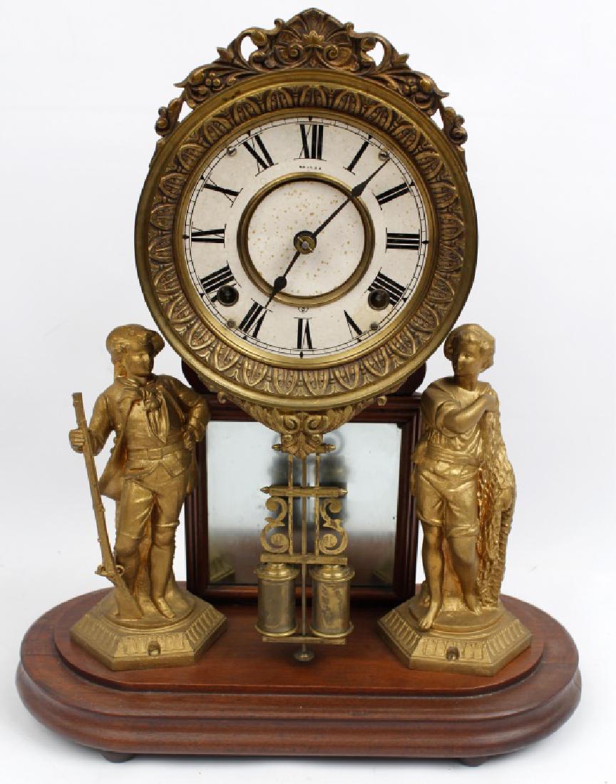 ANSONIA CRYSTAL PALACE PARLOR CLOCK: ANSONIA CRYSTAL PALACE PARLOR CLOCK Ansonia crystal palace parlor clock. Double figural statues on either side of the square mirror. Time and bell strike. Oak frame. ca. 1880.
