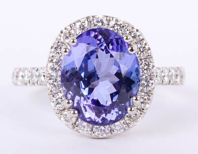 LADIES .950 PLATINUM TANZANITE & DIAMOND RING: LADIES .950 PLATINUM TANZANITE & DIAMOND RING Ladies platinum custom made diamond and tanzanite ring. Ring features one 4.23ct oval cut natural blue purple tanzanite center accented by .71ctw in