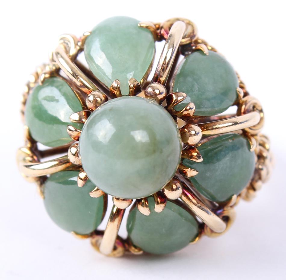 LADIES 14K YELLOW GOLD GREEN JADE DOME RING: LADIES 14K YELLOW GOLD GREEN JADE DOME RING Ladies 14k yellow gold and green jadeite ring. Features 6 pear cut jade accents around a single center round natural green jade center in dome setting. Weig