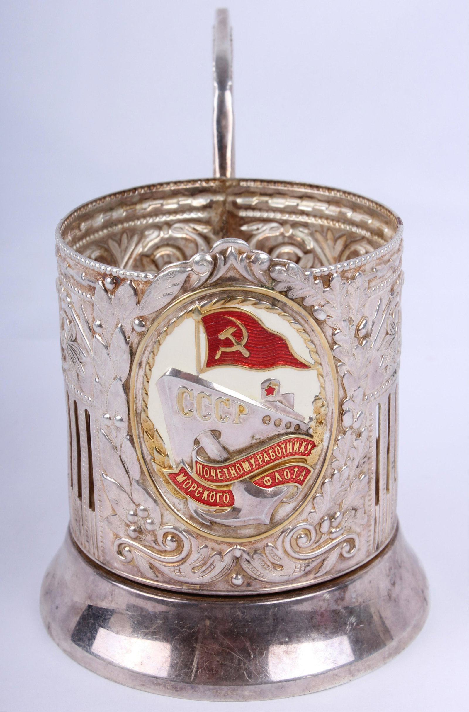 SOVIET UNION CCCP STERLING SILVER GLASS HOLDER: SOVIET UNION CCCP STERLING SILVER GLASS HOLDER Soviet Union sterling silver glass holder with elaborate metalwork and partially enameled central scene displaying a ship with CCCP written on it. Stampe