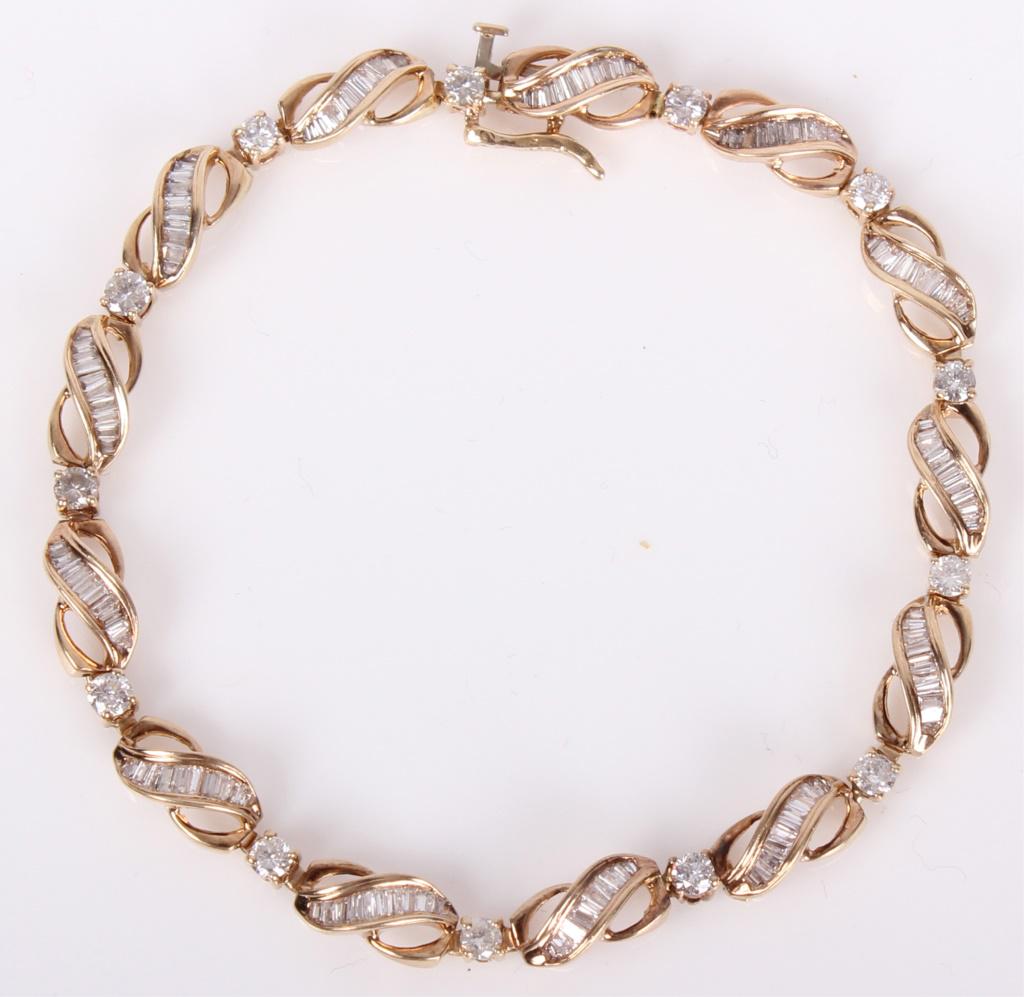 LADIES 14K YELLOW GOLD DIAMOND BRACELET: LADIES 14K YELLOW GOLD DIAMOND BRACELET 14k yellow gold diamond bracelet with a 3ctw round and baguette diamonds. Comes with Kay Jewelers lifetime diamond guarantee. Weight: 11.7 gramsSize: size 7
